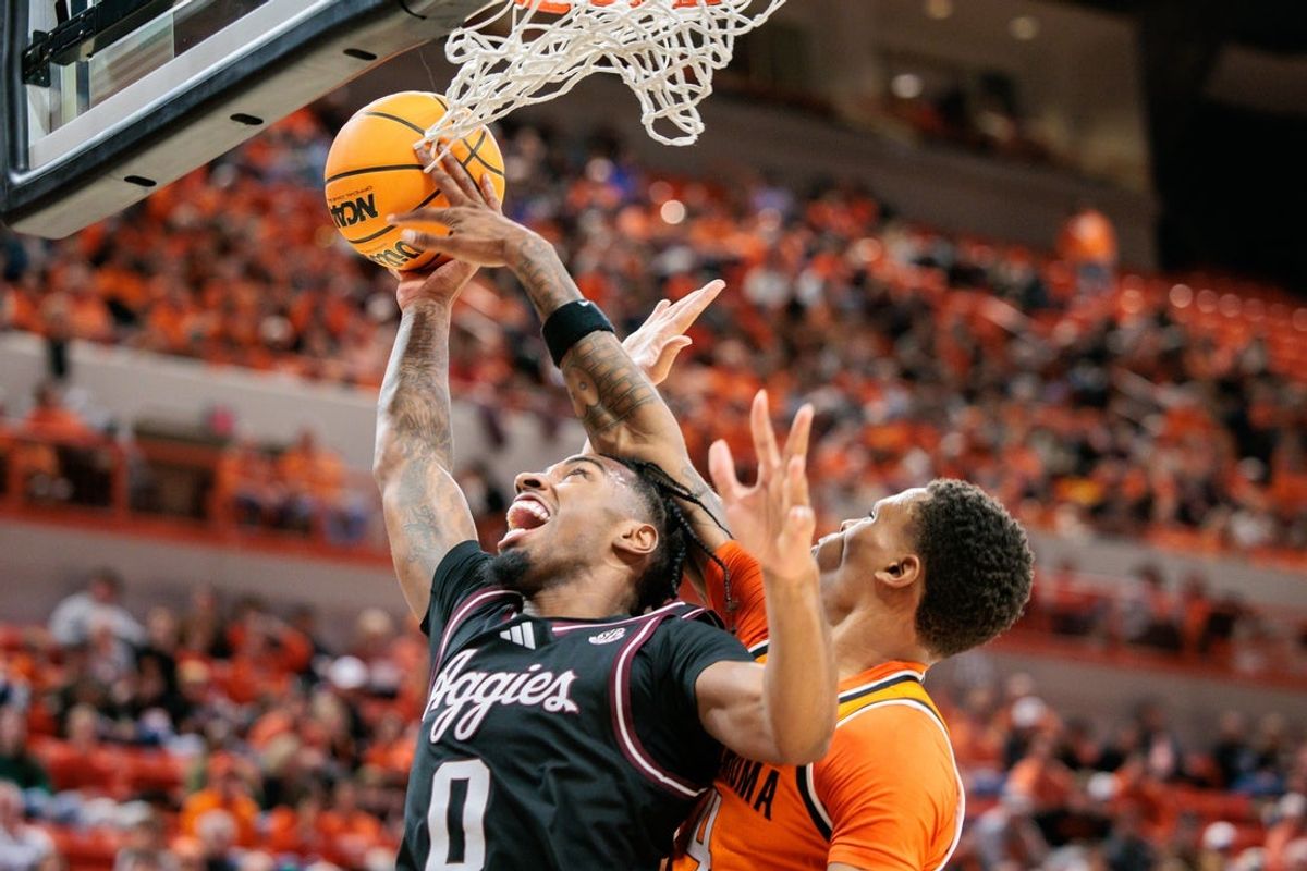 Nov 9, 2025; Stillwater, Oklahoma, USA; Texas A&M Aggies guard Marcus Hill (0) shoots the ball during the second half against the Oklahoma State Cowboys at Gallagher-Iba Arena. Mandatory Credit: William Purnell-Imagn Images