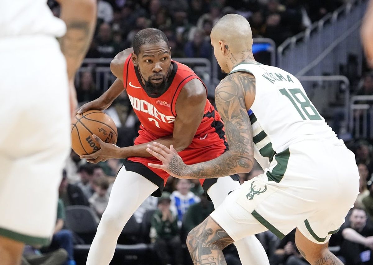 Nov 9, 2025; Milwaukee, Wisconsin, USA; Houston Rockets forward Kevin Durant (7) looks to drive against Milwaukee Bucks forward Kyle Kuzma (18) in the first half at Fiserv Forum. Mandatory Credit: Michael McLoone-Imagn Images