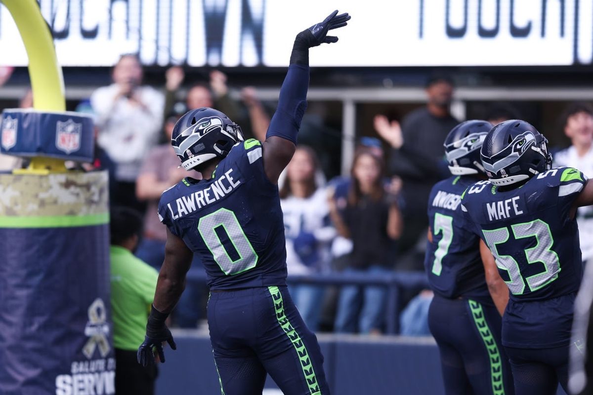 Nov 9, 2025; Seattle, Washington, USA; Seattle Seahawks defensive end DeMarcus Lawrence (0) celebrates after recovering a fumble to score a touchdown during the second quarter against the Arizona Cardinals at Lumen Field. Mandatory Credit: Kevin Ng-Imagn Images