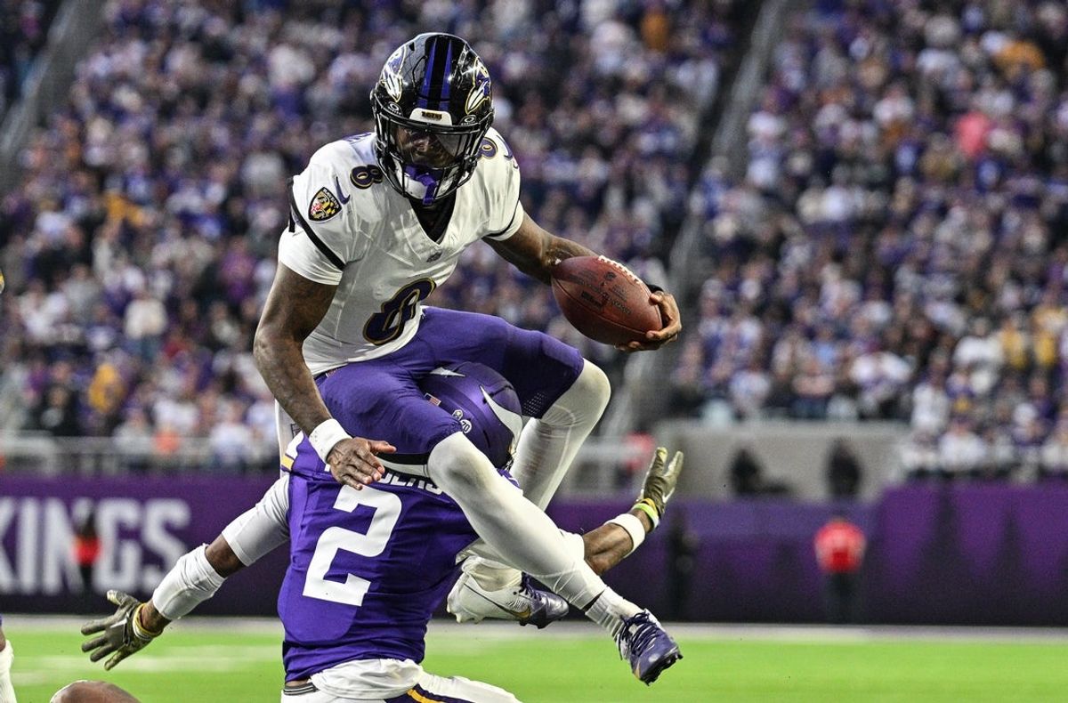Nov 9, 2025; Minneapolis, Minnesota, USA; Baltimore Ravens quarterback Lamar Jackson (8) runs the ball as Minnesota Vikings cornerback Isaiah Rodgers (2) makes the tackle during the third quarter at U.S. Bank Stadium. Mandatory Credit: Jeffrey Becker-Imagn Images