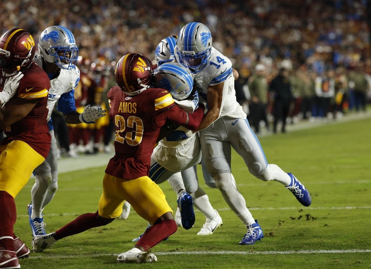Nov 9, 2025; Landover, Maryland, USA; Detroit Lions running back Jahmyr Gibbs (0) runs for a touchdown past Washington Commanders cornerback Trey Amos (23) during the second quarter at Northwest Stadium. Mandatory Credit: Geoff Burke-Imagn Images