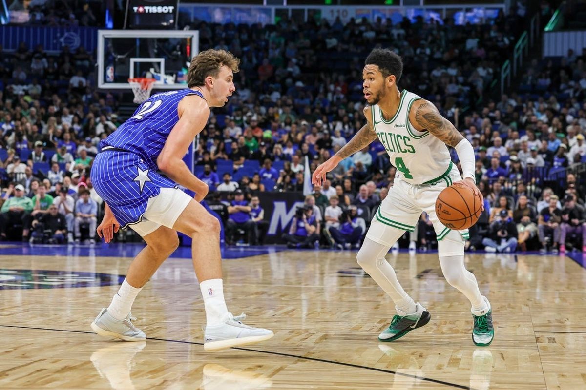 Nov 9, 2025; Orlando, Florida, USA; Boston Celtics guard Anfernee Simons (4) handles the ball in front of Orlando Magic forward Franz Wagner (22) during the second quarter at Kia Center. Mandatory Credit: Mike Watters-Imagn Images
