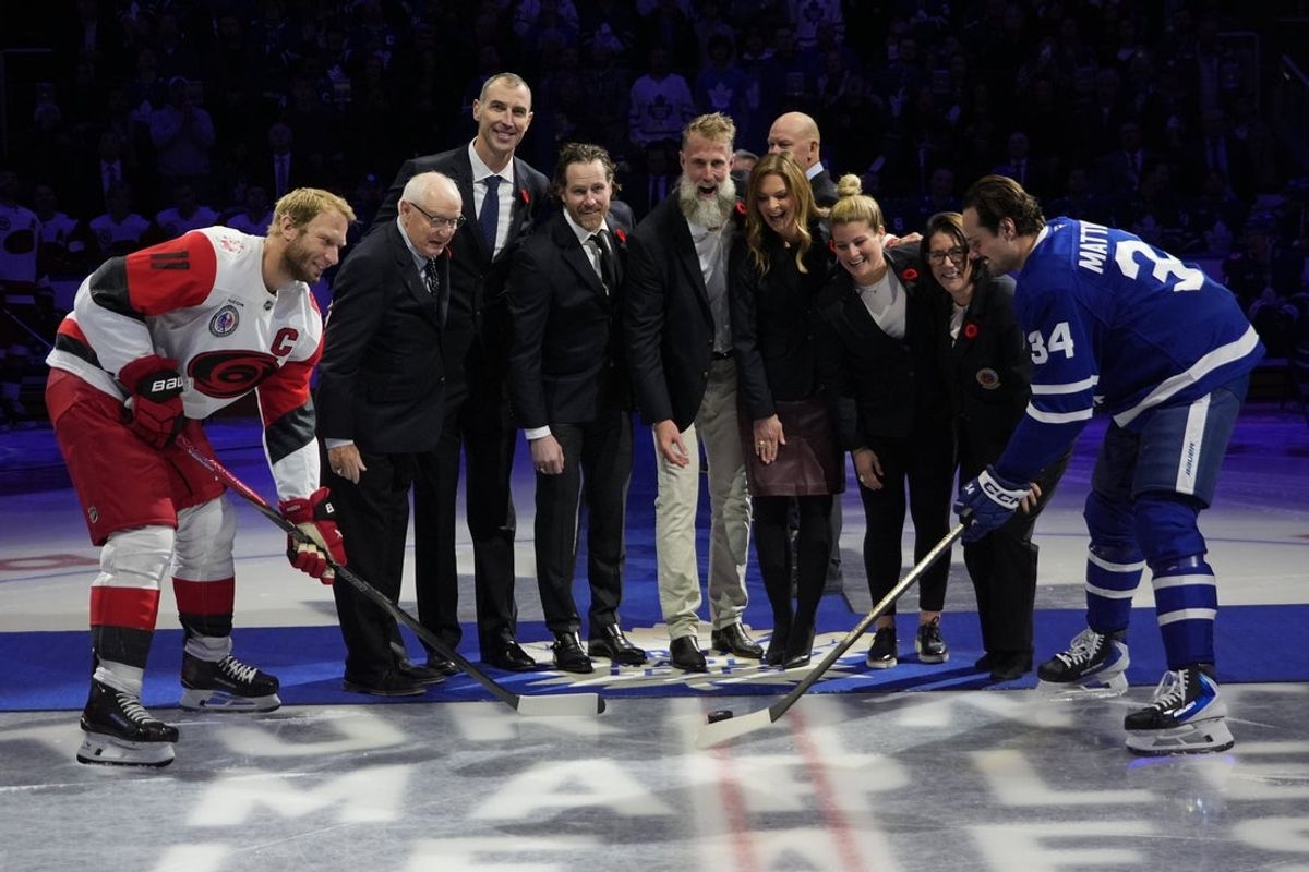 Nov 9, 2025; Toronto, Ontario, CAN; 2025 Hockey Hall of Fame inductees (left to right) Jack Parker, Zdeno Chara,  Duncan Keith, Joe Thornton, Jennifer Botteril, Brianna Decker, and  Daniele Sauvageau drop the puck to Carolina Hurricanes forward Jordan Staal (11) and Toronto Maple Leafs forward Auston Matthews (34) before the start of the game at Scotiabank Arena. Mandatory Credit: John E. Sokolowski-Imagn Images