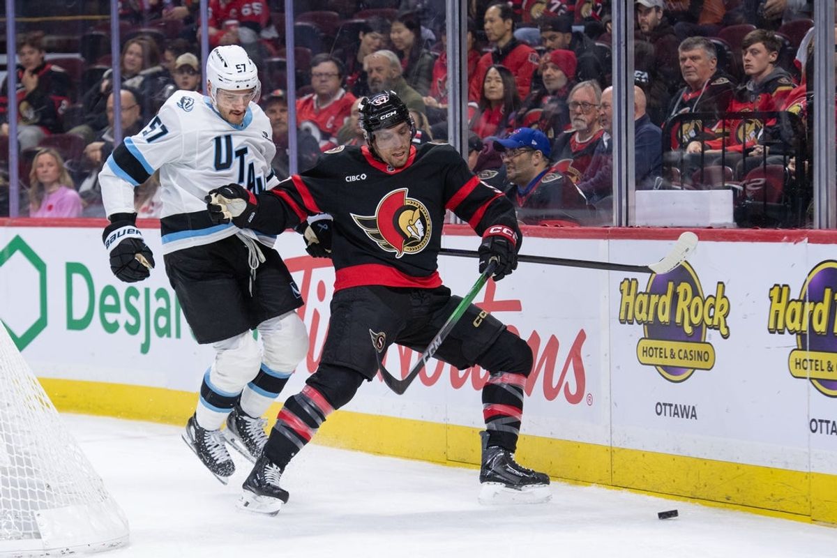 Nov 9, 2025; Ottawa, Ontario, CAN; Utah Mammoth defenseman Nick DeSimone (57) and  Ottawa Senators left wing David Perron (57) battle for control of the puck in the first period at the Canadian Tire Centre. Mandatory Credit: Marc DesRosiers-IMAGN Images