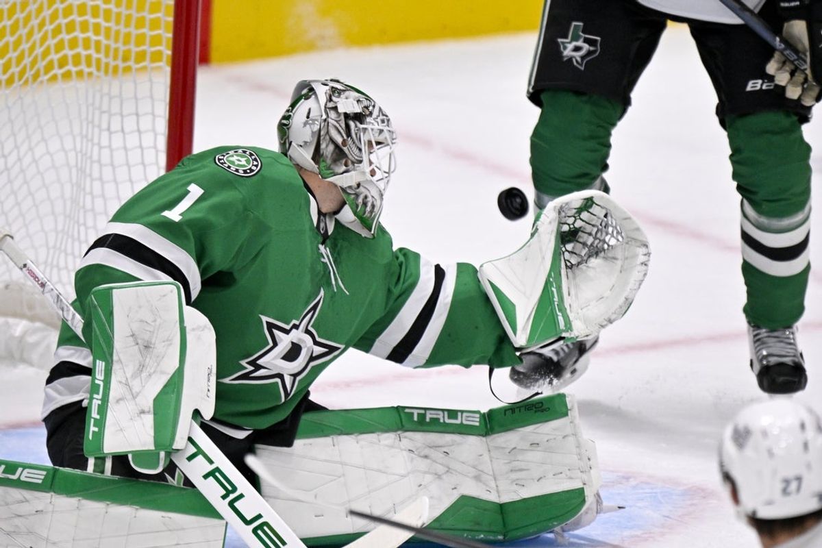 Nov 9, 2025; Dallas, Texas, USA; Dallas Stars goaltender Casey Desmith (1) attempts to make a glove save on a Seattle Kraken shot during the second period at the American Airlines Center. Mandatory Credit: Jerome Miron-Imagn Images