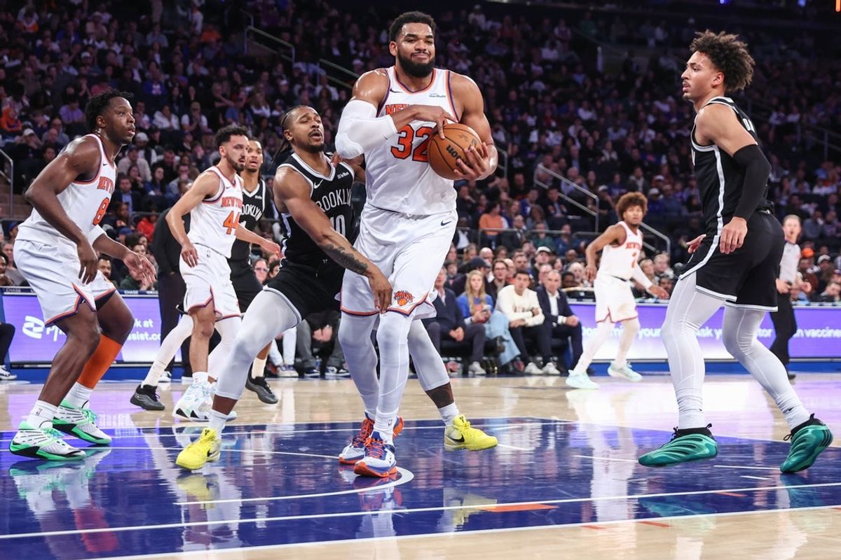 Nov 9, 2025; New York, New York, USA;  New York Knicks center Karl-Anthony Towns (32) grabs a rebound away from Brooklyn Nets guard Tyson Etienne (10) in the fourth quarter at Madison Square Garden. Mandatory Credit: Wendell Cruz-Imagn Images