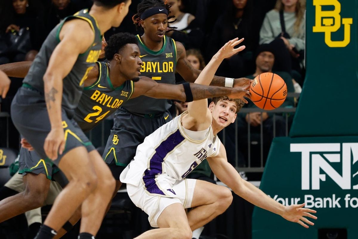 Nov 9, 2025; Waco, Texas, USA;  Baylor Bears guard Tounde Yessoufou (24) deflects a pass intended for Washington Huskies forward Hannes Steinbach (6) during the first half at Paul and Alejandra Foster Pavilion. Mandatory Credit: Chris Jones-Imagn Images