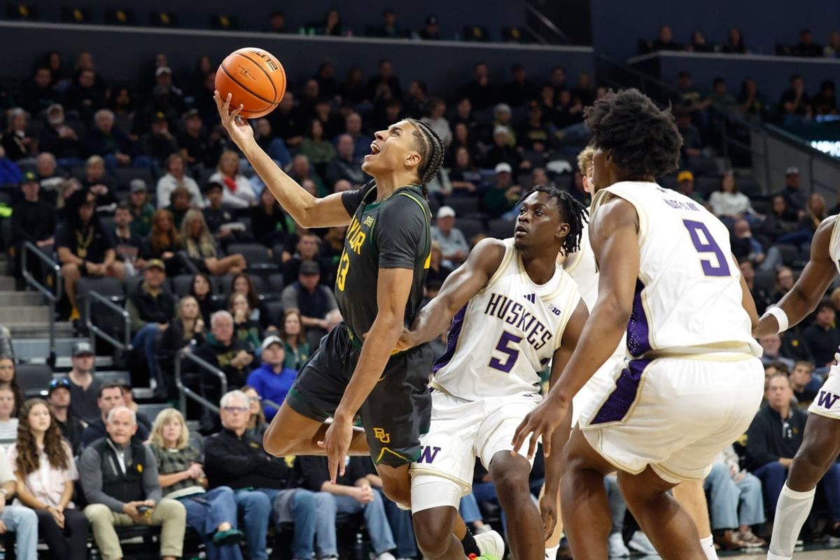 Nov 9, 2025; Waco, Texas, USA;  Baylor Bears guard Cameron Carr (43) is fouled driving to the basket by Washington Huskies guard Zoom Diallo (5) during the first half at Paul and Alejandra Foster Pavilion. Mandatory Credit: Chris Jones-Imagn Images