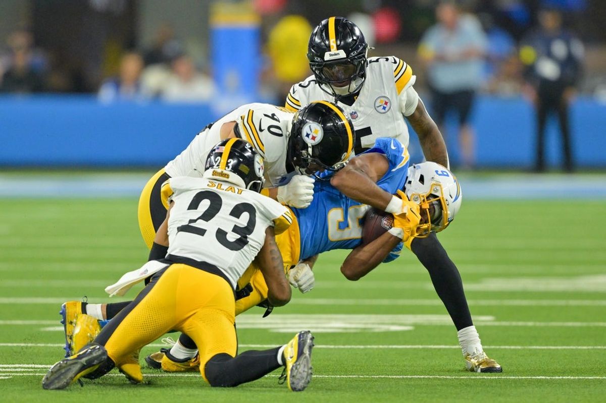 Nov 9, 2025; Inglewood, California, USA; Pittsburgh Steelers cornerback Darius Slay (23), linebacker T.J. Watt (90) and cornerback Jalen Ramsey (5) tackle Los Angeles Chargers wide receiver Tre' Harris (9) during the second quarter of the game at SoFi Stadium. Mandatory Credit: Jayne Kamin-Oncea-Imagn Images