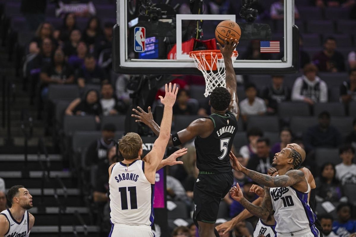 Nov 9, 2025; Sacramento, California, USA; Minnesota Timberwolves guard Anthony Edwards (5) drives to the basket against Sacramento Kings forward Domantas Sabonis (11) during the second quarter at Golden 1 Center. Mandatory Credit: Justine Willard-Imagn Images