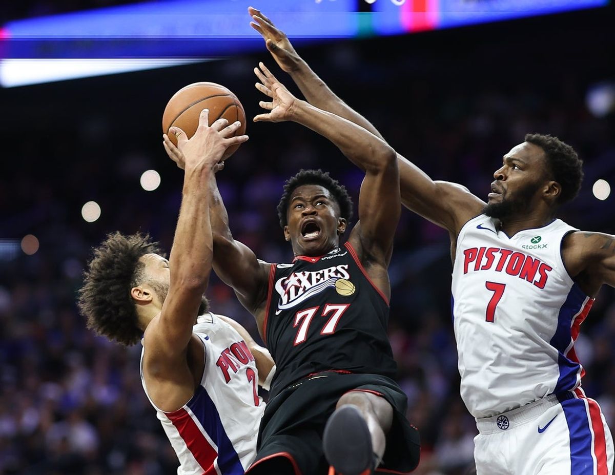 Nov 9, 2025; Philadelphia, Pennsylvania, USA; Philadelphia 76ers guard VJ Edgecombe (77) is fouled by Detroit Pistons guard Cade Cunningham (2) and forward Paul Reed (7) while driving for a shot during the third quarter at Xfinity Mobile Arena. Mandatory Credit: Bill Streicher-Imagn Images