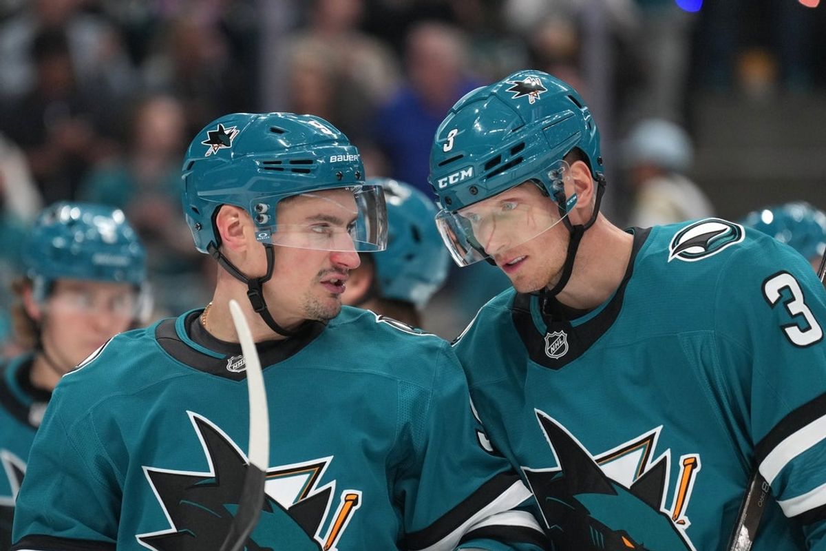 Nov 8, 2025; San Jose, California, USA; San Jose Sharks defensemen Dmitry Orlov (left) and John Klingberg (3) talk during the third period against the Florida Panthers at SAP Center at San Jose. Mandatory Credit: Darren Yamashita-Imagn Images