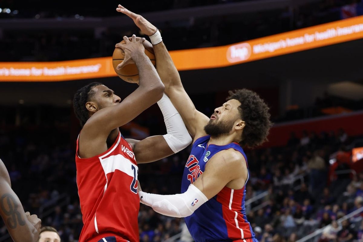 Nov 10, 2025; Detroit, Michigan, USA;  Washington Wizards center Alex Sarr (20) shoots on Detroit Pistons guard Cade Cunningham (2) in the first half at Little Caesars Arena. Mandatory Credit: Rick Osentoski-Imagn Images