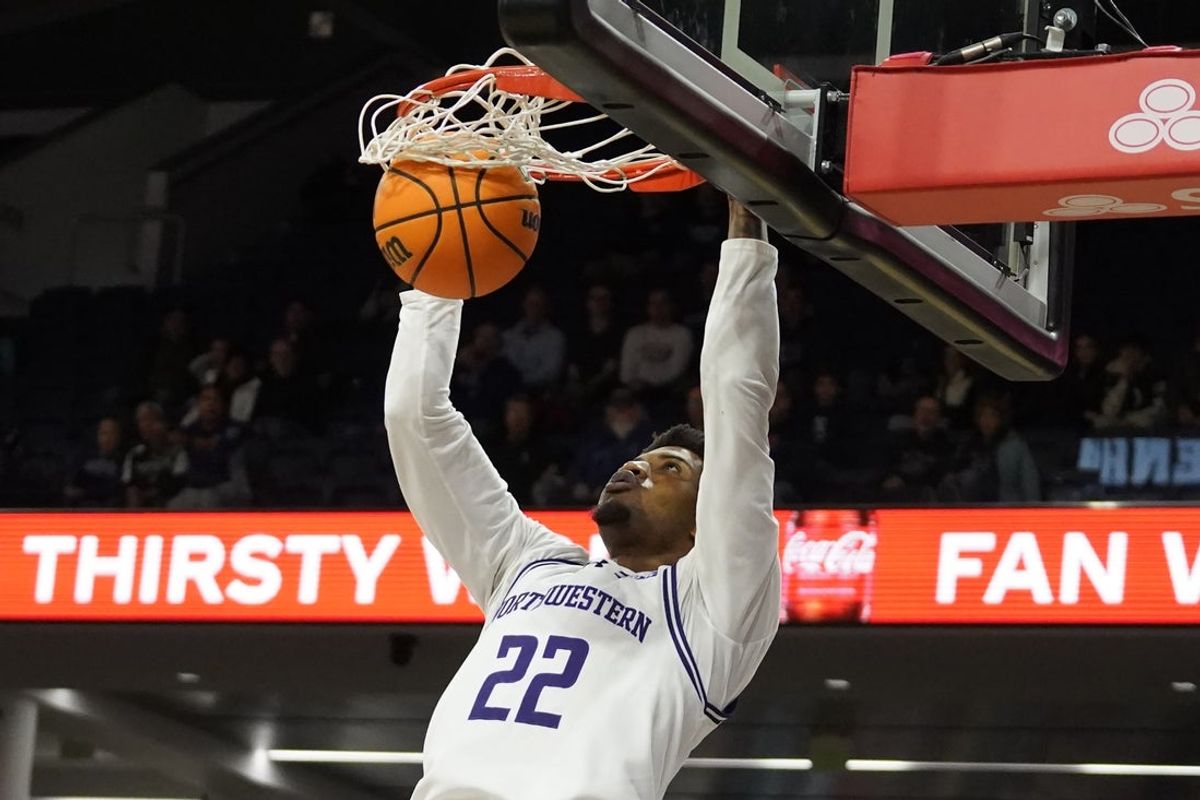 Northwestern Wildcats forward Arrinten Page (22) dunks the ball against the Cleveland State Vikings during the first half at Welsh-Ryan Arena. Mandatory Credit: David Banks-Imagn Images