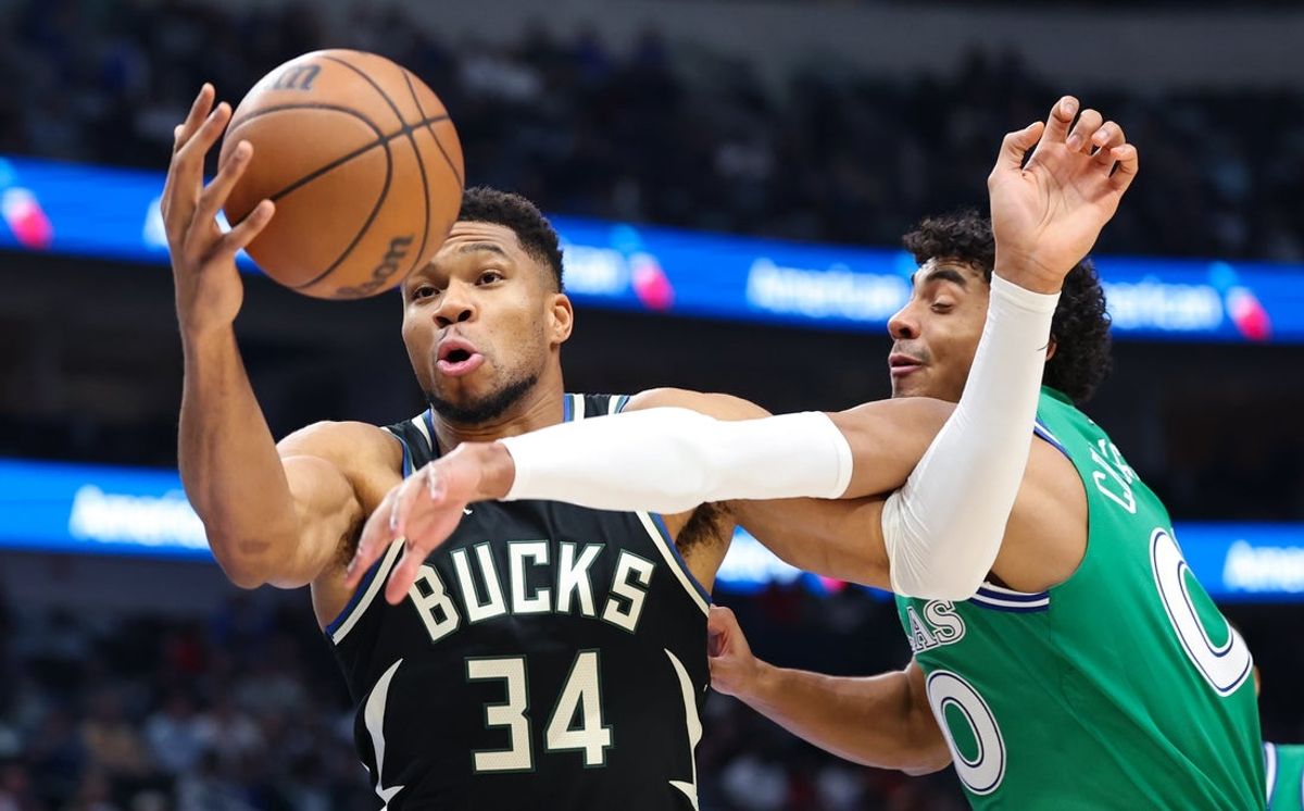 Nov 10, 2025; Dallas, Texas, USA;  Milwaukee Bucks forward Giannis Antetokounmpo (34) and Dallas Mavericks guard Max Christie (00) go for the ball during the first quarter at American Airlines Center. Mandatory Credit: Kevin Jairaj-Imagn Images