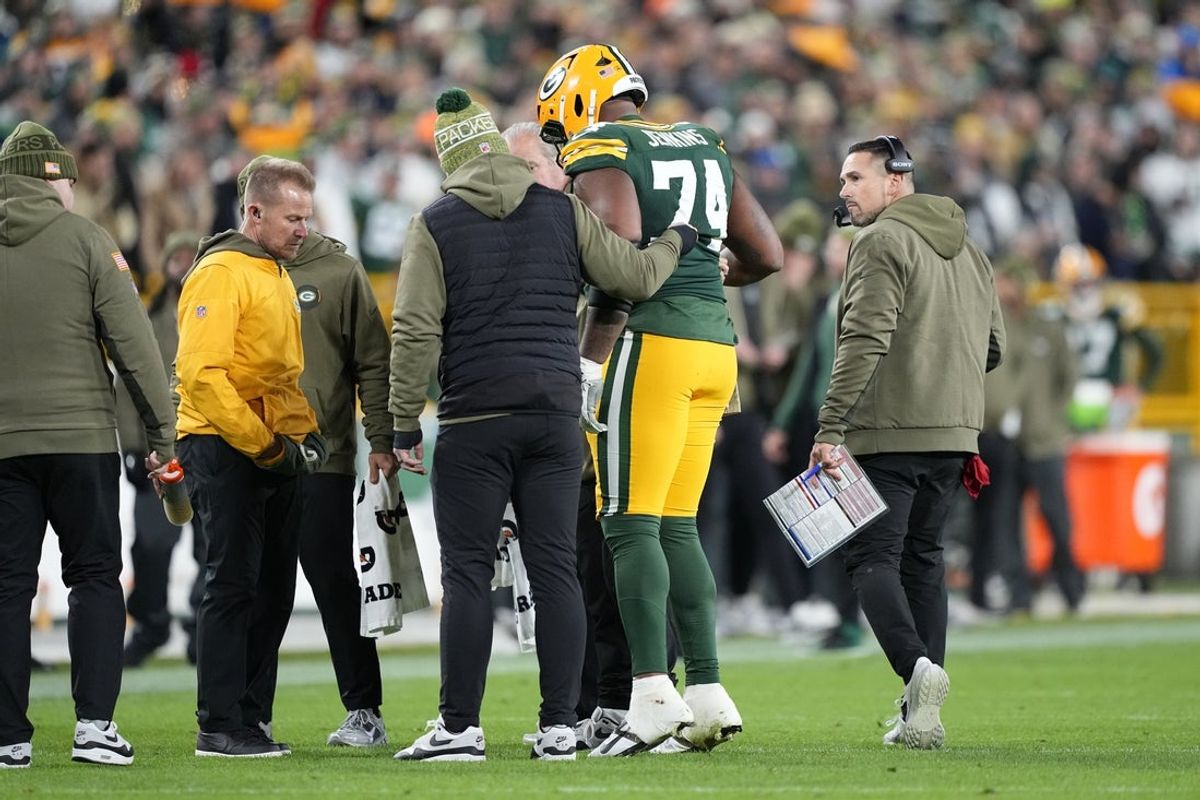 Nov 10, 2025; Green Bay, Wisconsin, USA; Green Bay Packers guard Elgton Jenkins (74) comes off the file with an apparent injury against the Green Bay Packers in the first half at Lambeau Field. Mandatory Credit: Jeff Hanisch-Imagn Images