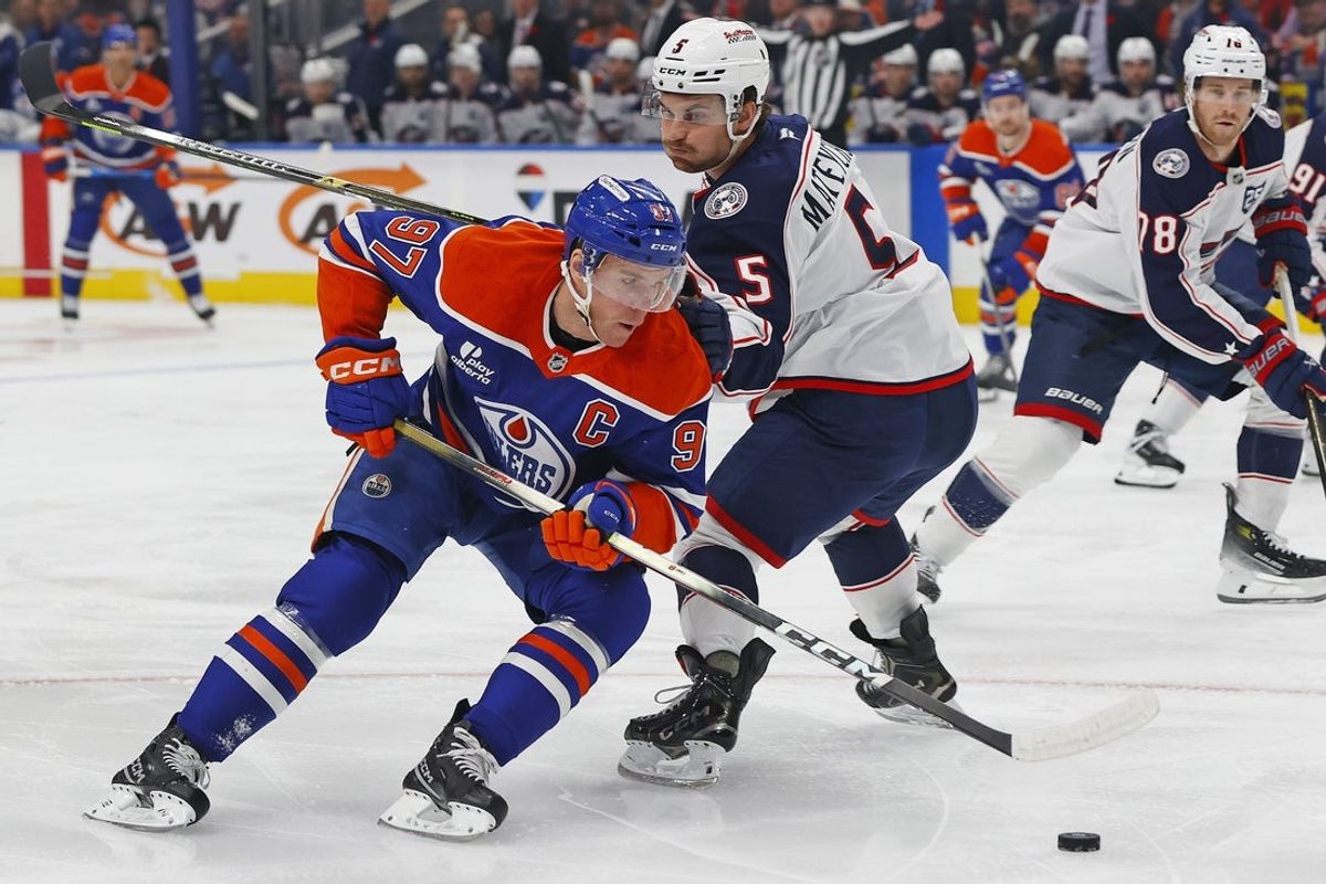 Nov 10, 2025; Edmonton, Alberta, CAN; Edmonton Oilers forward Connor McDavid (97) carries the puck around Columbus Blue Jackets defenseman Denton Mateychuk (5) during the first period at Rogers Place. Mandatory Credit: Perry Nelson-Imagn Images
