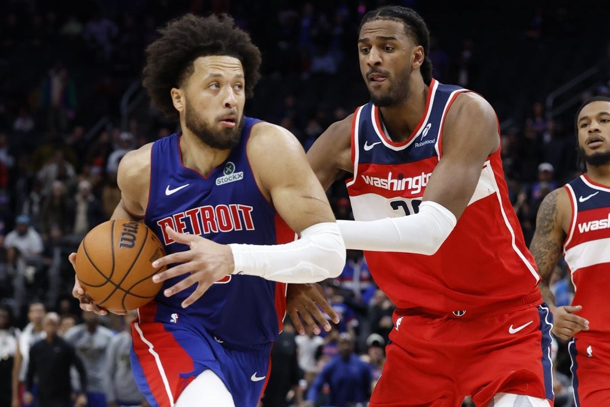 Nov 10, 2025; Detroit, Michigan, USA;  Detroit Pistons guard Cade Cunningham (2) dribbles defended by Washington Wizards center Alex Sarr (20) in overtime at Little Caesars Arena. Mandatory Credit: Rick Osentoski-Imagn Images
