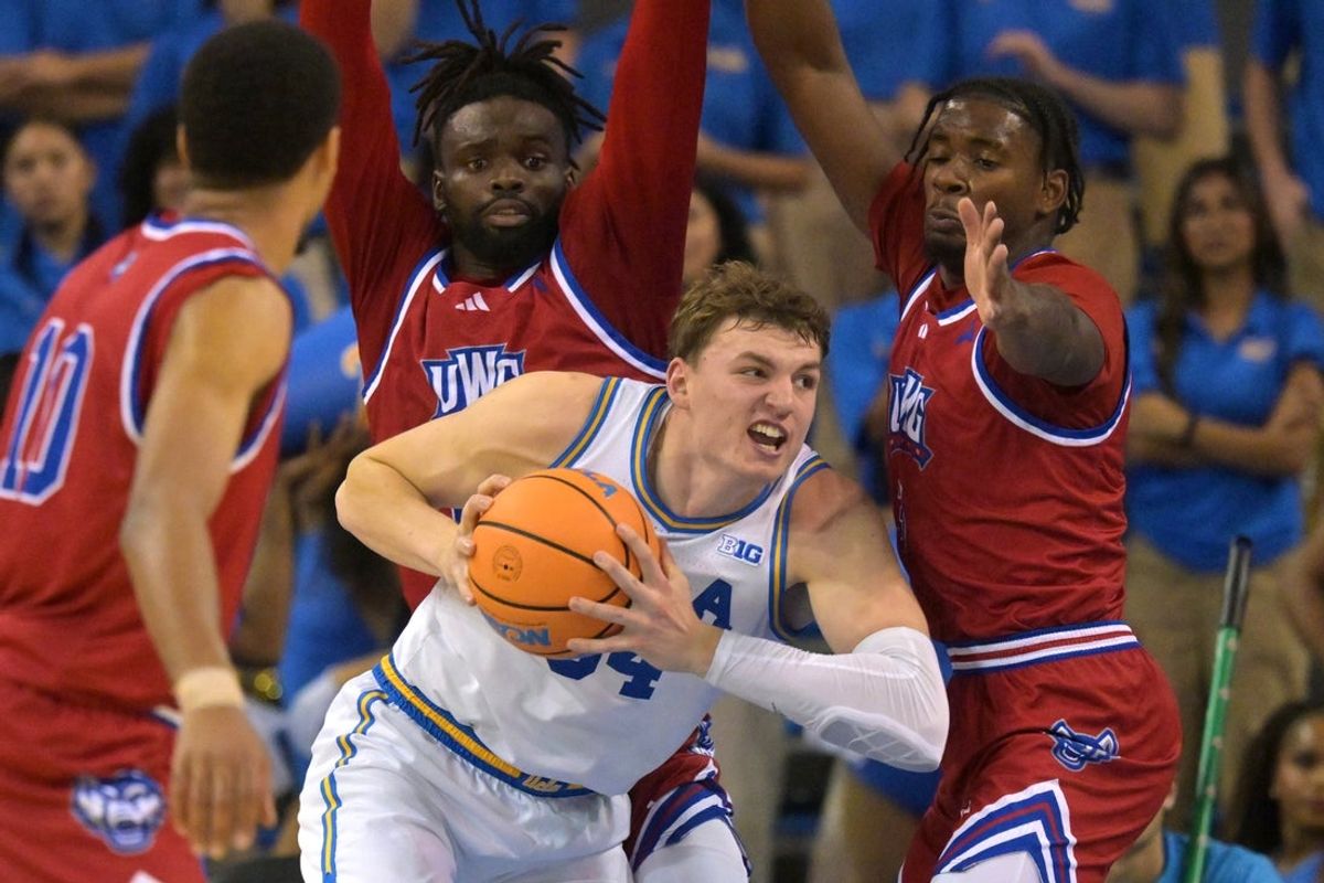 Nov 10, 2025; Los Angeles, California, USA;  UCLA Bruins forward Tyler Bilodeau (34) is defended by West Georgia Wolves guard Josh Smith (10), forward Kenneth Chime (22) and forward Xavier Shegog (3) as he goes up for a basket during the first half at Pauley Pavilion presented by Wescom Financial. Mandatory Credit: Jayne Kamin-Oncea-Imagn Images