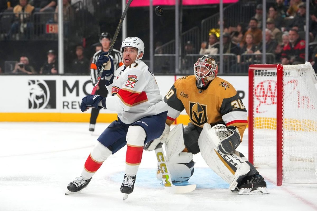 Nov 10, 2025; Las Vegas, Nevada, USA; Vegas Golden Knights goaltender Carl Lindbom (30) tracks a floating puck behind Florida Panthers center Evan Rodrigues (17) during the first period at T-Mobile Arena. Mandatory Credit: Stephen R. Sylvanie-Imagn Images
