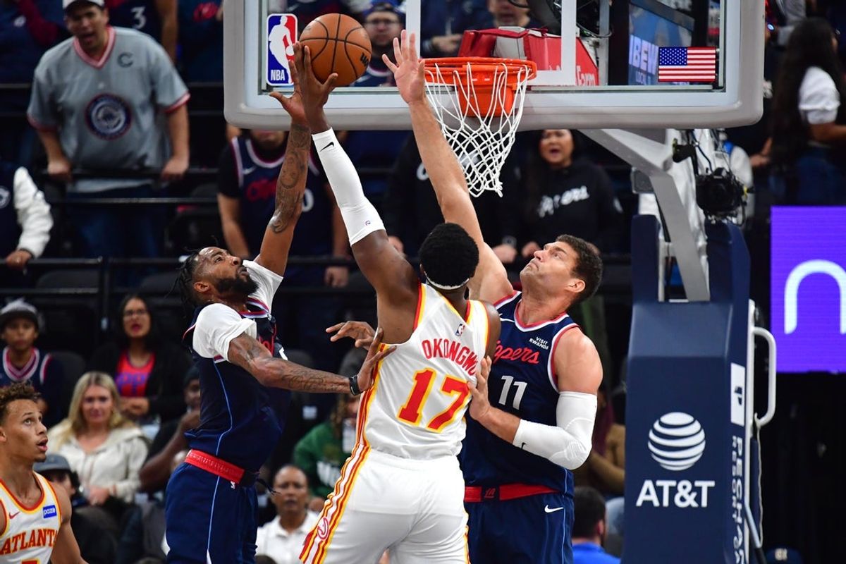 Nov 10, 2025; Inglewood, California, USA; Atlanta Hawks forward Onyeka Okongwu (17) shoots against Los Angeles Clippers forward Derrick Jones Jr. (5) and center Brook Lopez (11) during the first half at Intuit Dome. Mandatory Credit: Gary A. Vasquez-Imagn Images