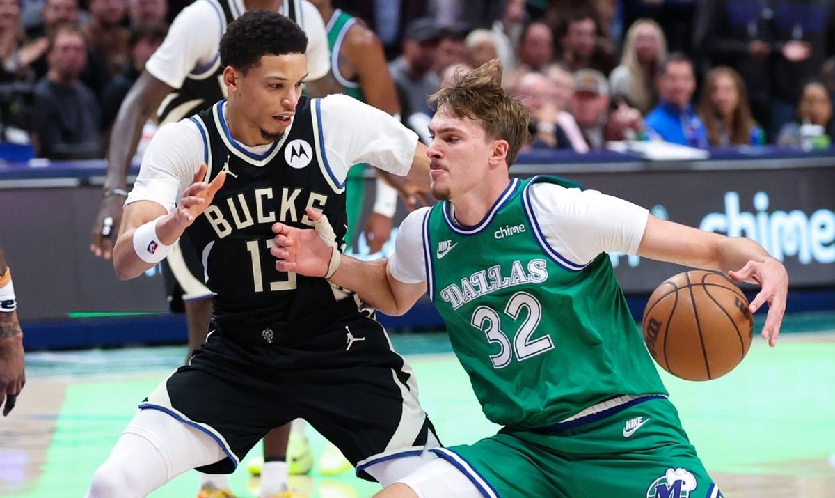 Nov 10, 2025; Dallas, Texas, USA;  Dallas Mavericks forward Cooper Flagg (32) drives to the basket as Milwaukee Bucks guard Ryan Rollins (13) defends during the fourth quarter at American Airlines Center. Mandatory Credit: Kevin Jairaj-Imagn Images