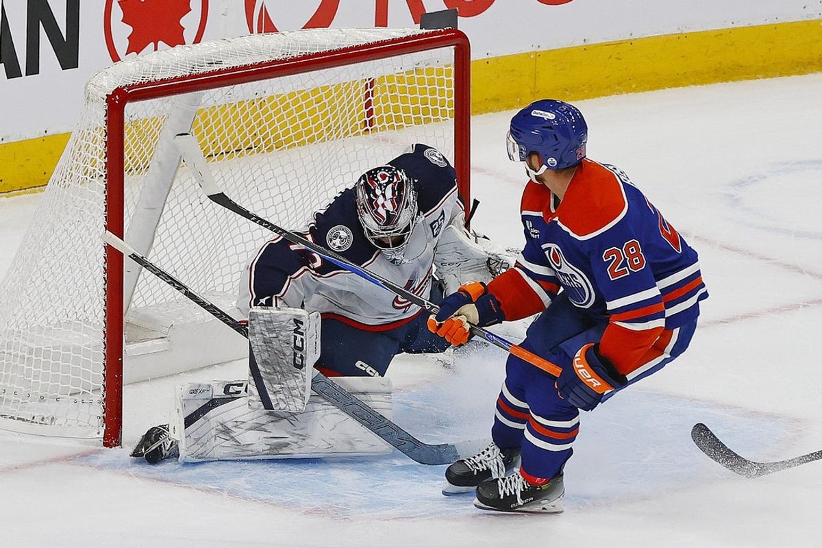 Nov 10, 2025; Edmonton, Alberta, CAN; Edmonton Oilers forward Jack Roslovic (28) scores during overtime against Columbus Blue Jackets goaltender Jet Greaves (73)  at Rogers Place. Mandatory Credit: Perry Nelson-Imagn Images