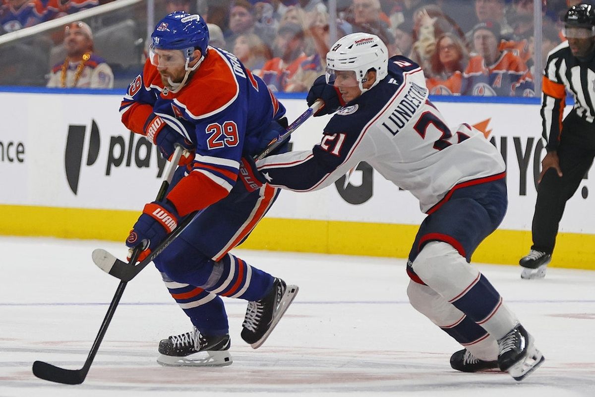 Nov 10, 2025; Edmonton, Alberta, CAN; Edmonton Oilers forward Leon Draisaitl (29) and Columbus Blue Jackets forward Isac Lundestrom (21) battle for a loose puck during the third period at Rogers Place. Mandatory Credit: Perry Nelson-Imagn Images