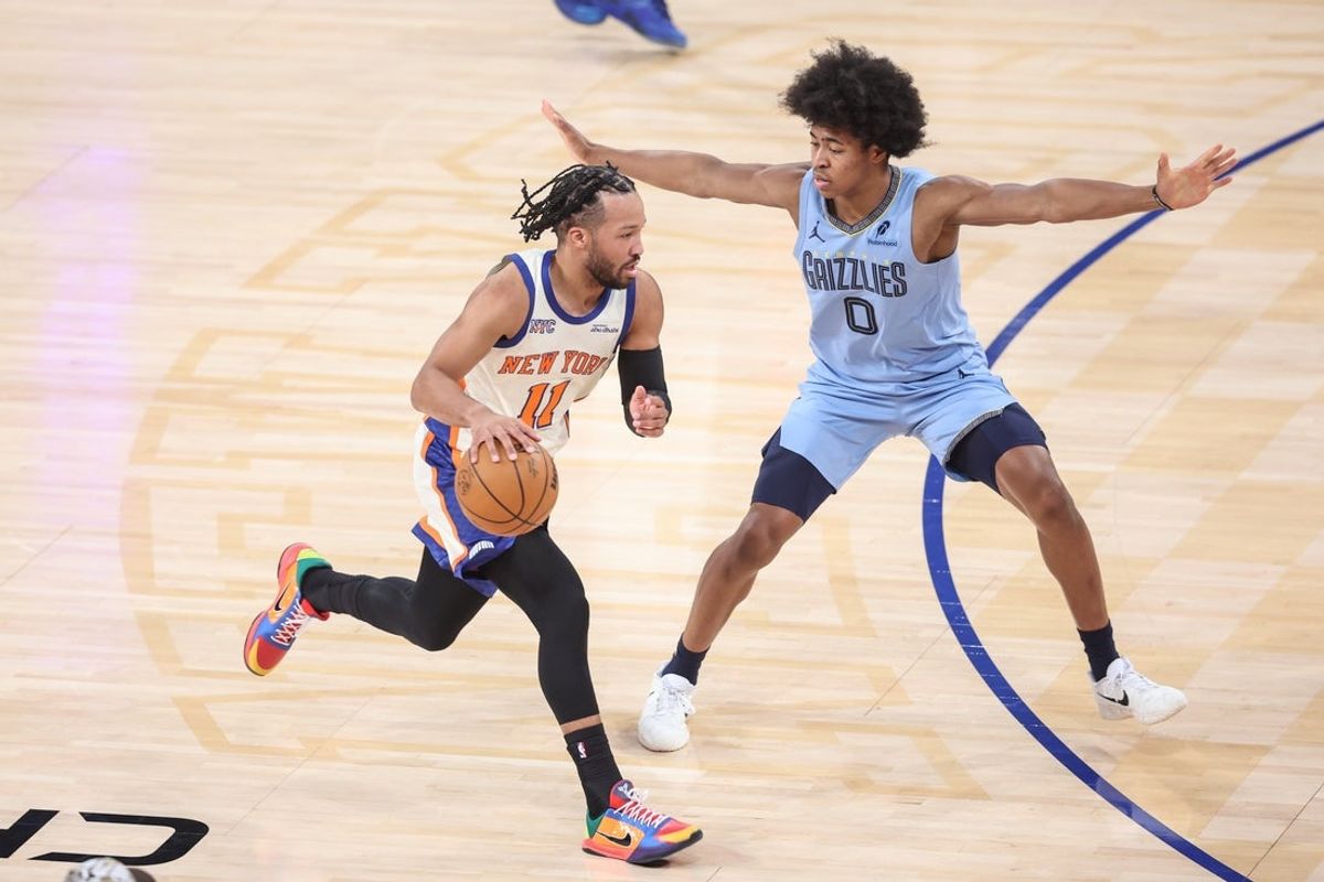 Nov 11, 2025; New York, New York, USA;  New York Knicks guard Jalen Brunson (11) looks to drive past Memphis Grizzlies forward Jaylen Wells (0) in the first quarter at Madison Square Garden. Mandatory Credit: Wendell Cruz-Imagn Images