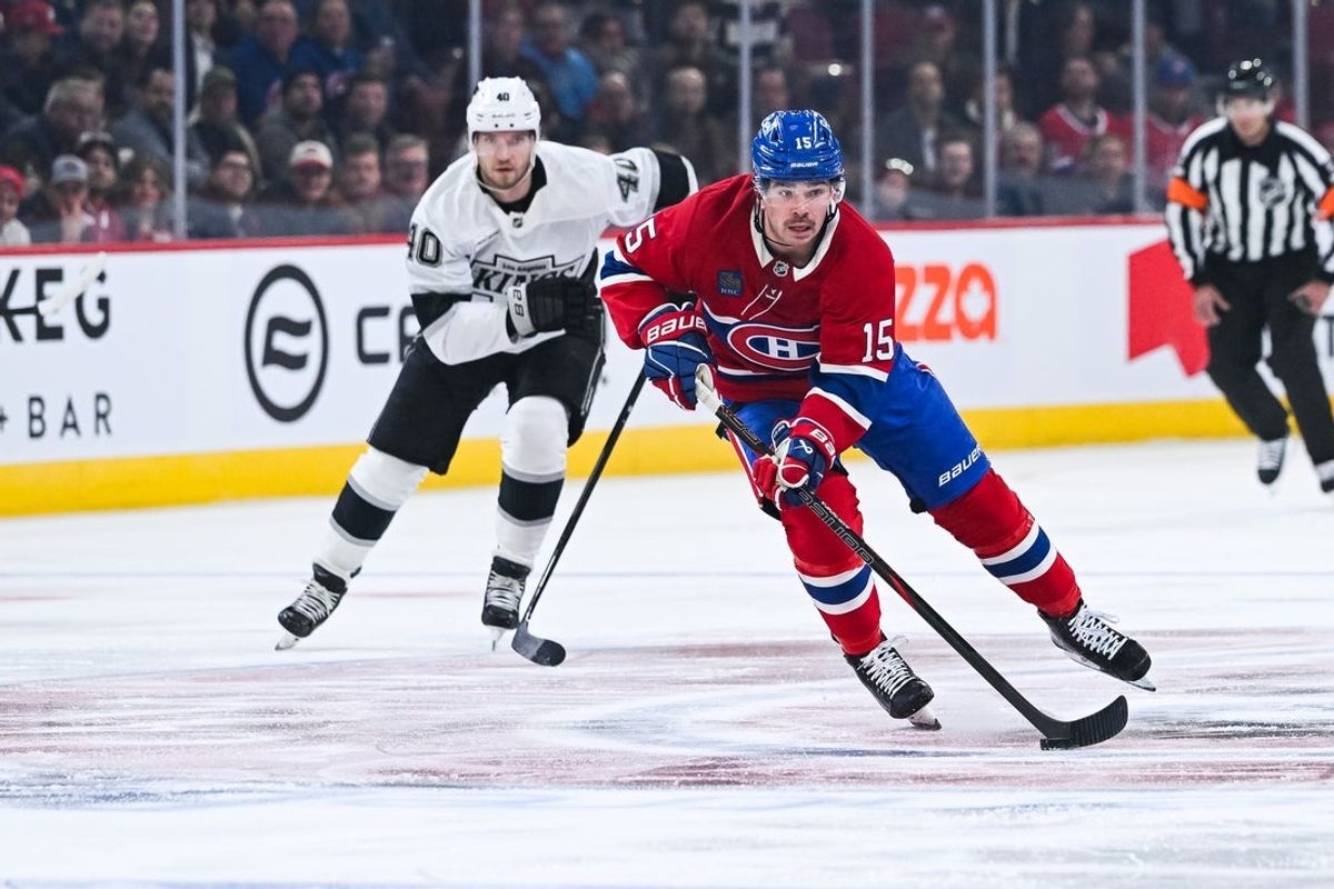 Nov 11, 2025; Montreal, Quebec, CAN; Montreal Canadiens center Alex Newhook (15) plays the puck against Los Angeles Kings right wing Joel Armia (40) during the first period at Bell Centre. Mandatory Credit: David Kirouac-Imagn Images
