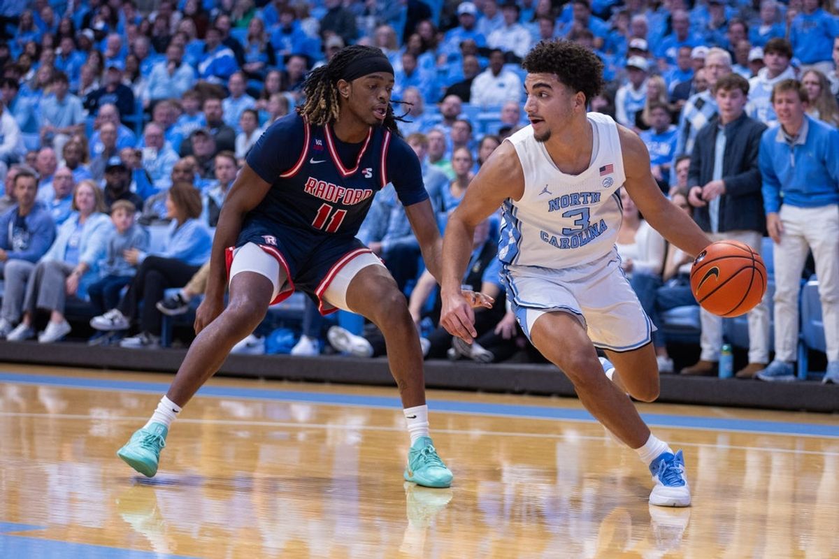 Nov 11, 2025; Chapel Hill, North Carolina, USA; Radford Highlanders guard Jr. Dennis Parker (11) presses North Carolina Tar Heels guard Derek Dixon (3) in the first half at Dean E. Smith Center. Mandatory Credit: Scott Kinser-Imagn Images