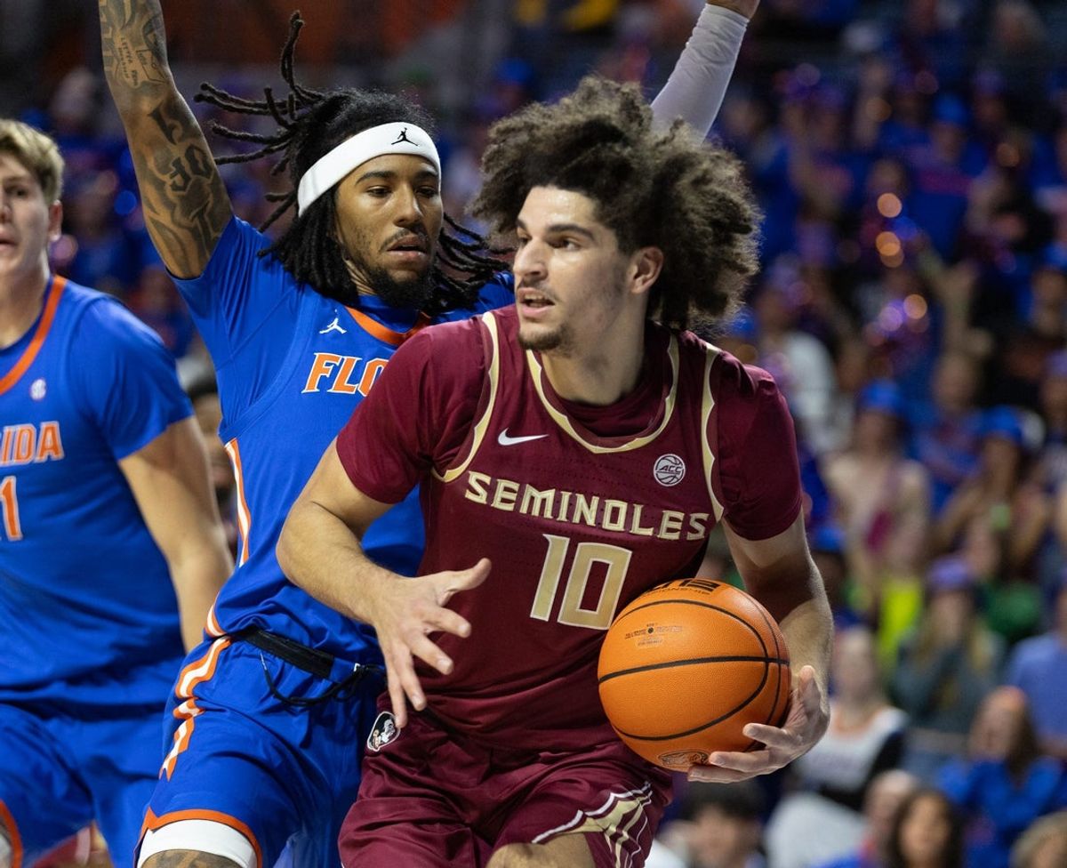 Florida State guard Lajae Jones (10) drives on Florida guard Boogie Fland (0) during the first half of an NCAA mens basketball game at Exactec Areana at the Steven C. O Connell Center in Gainesville, FL on Tuesday, November 11, 2025. [Alan Youngblood/Gainesville Sun]