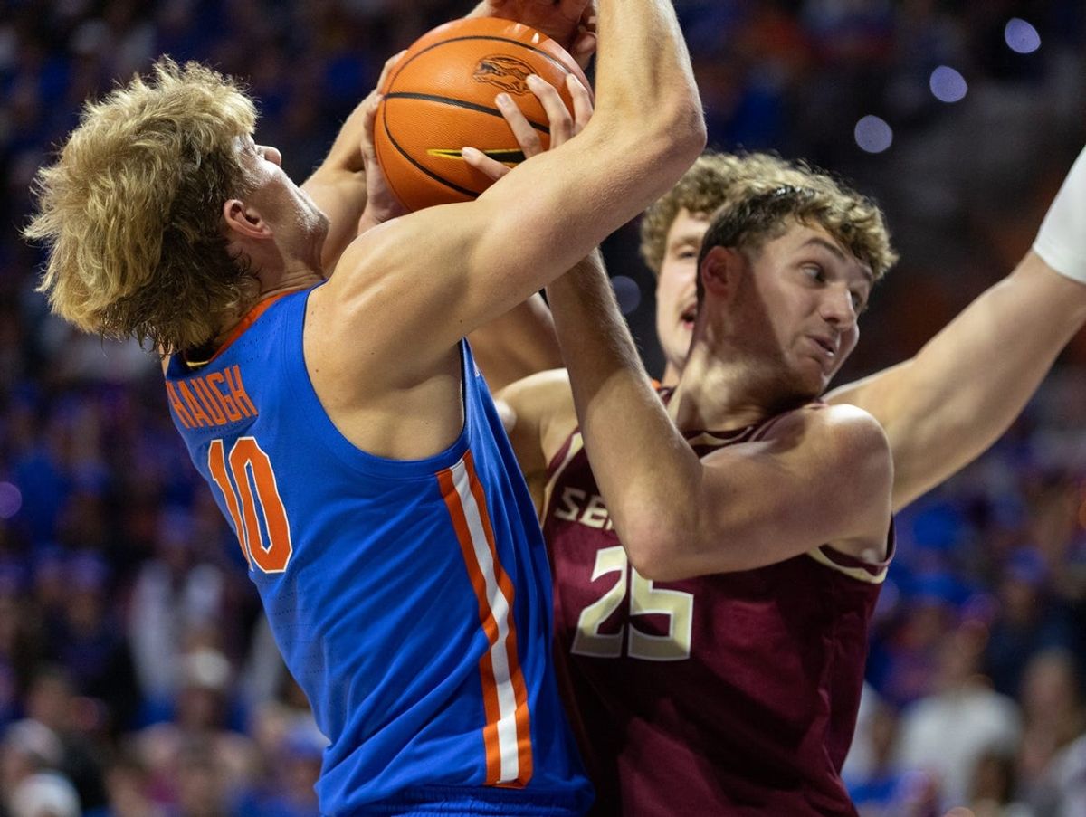 Florida forward Thomas Haugh (10) and Florida State forward Alex Steen (25) battle for the rebound during the first half of an NCAA mens basketball game at Exactec Areana at the Steven C. O Connell Center in Gainesville, FL on Tuesday, November 11, 2025. [Alan Youngblood/Gainesville Sun]