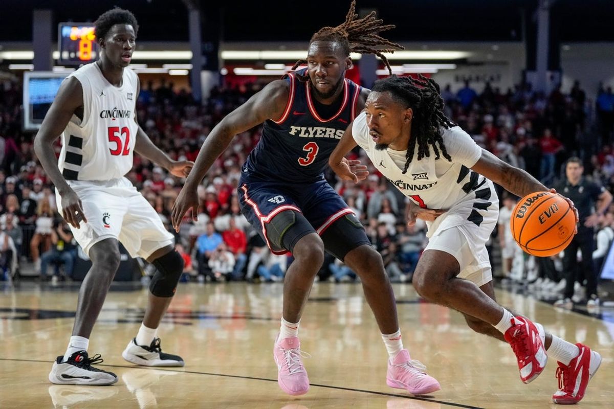 Cincinnati Bearcats guard Day Day Thomas (1) drives against Dayton Flyers forward Jaiun Simon (3) in the first half of the NCAA Men’s Basketball game between the Cincinnati Bearcats and the Dayton Flyers at Fifth Third Arena in Cincinnati on Tuesday, Nov. 11, 2025.