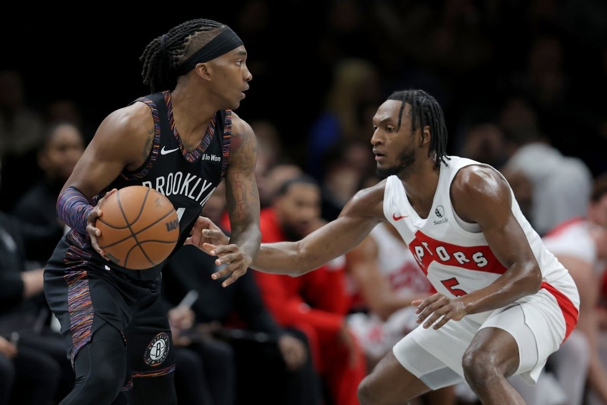 Nov 11, 2025; Brooklyn, New York, USA; Brooklyn Nets guard Terance Mann (14) controls the ball against Toronto Raptors guard Immanuel Quickley (5) during the second quarter at Barclays Center. Mandatory Credit: Brad Penner-Imagn Images