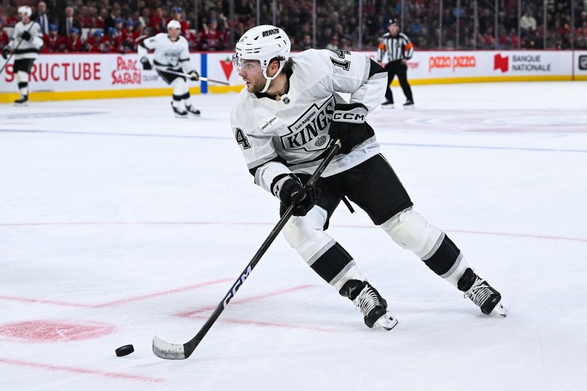 Nov 11, 2025; Montreal, Quebec, CAN; Los Angeles Kings right wing Alex Laferriere (14) plays the puck against the Montreal Canadiens during the second period at Bell Centre. Mandatory Credit: David Kirouac-Imagn Images