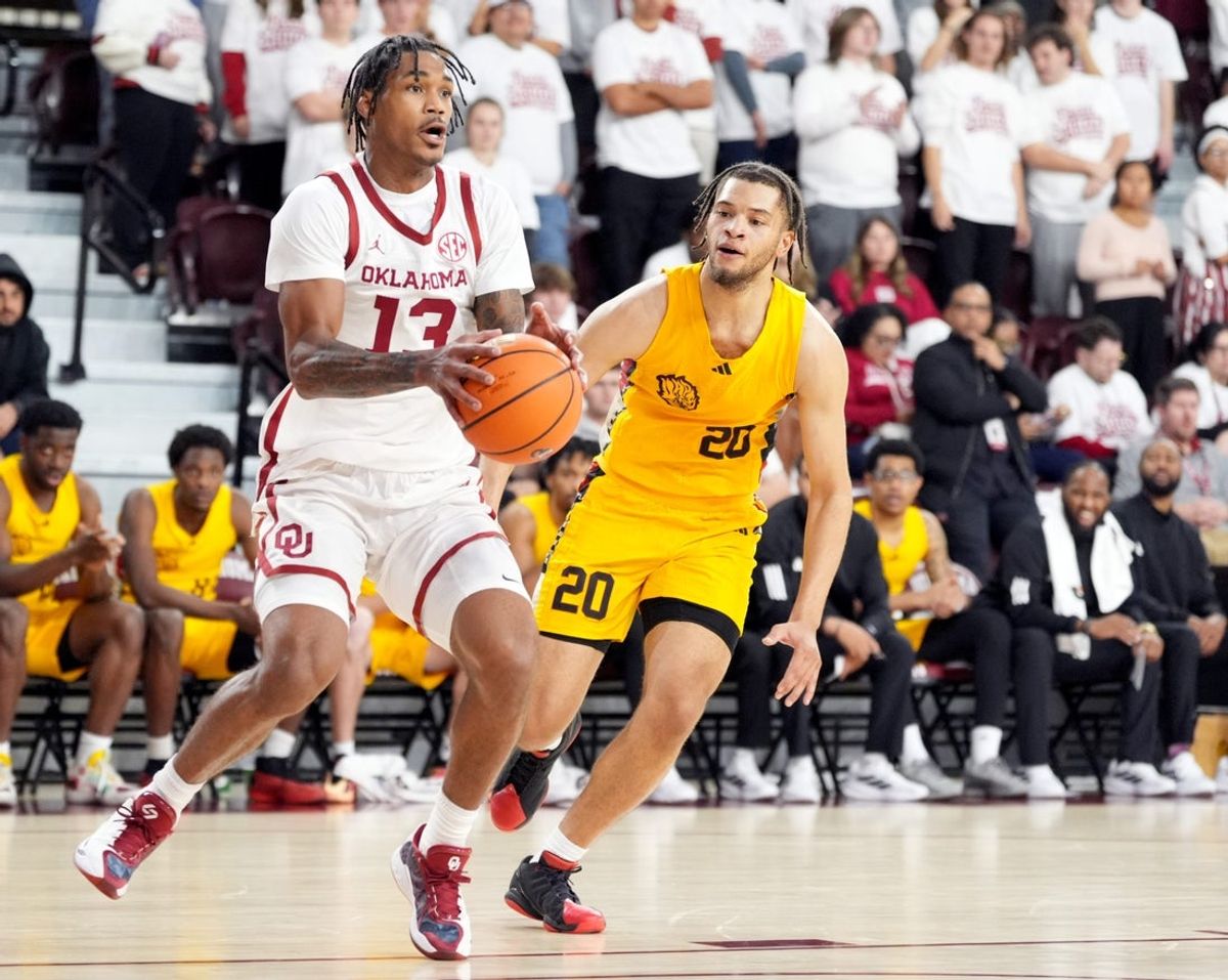 Oklahoma's Tae Davis (13) drives to the basket as Arkansas-Pine Bluff 's Trevon Payton (20) defends in the first half of the college basketball game between the University of Oklahoma Sooners and the University of Arkansas-Pine Bluff at McCasland Field House in Norman, Okla., Tuesday Nov., 11, 2025.