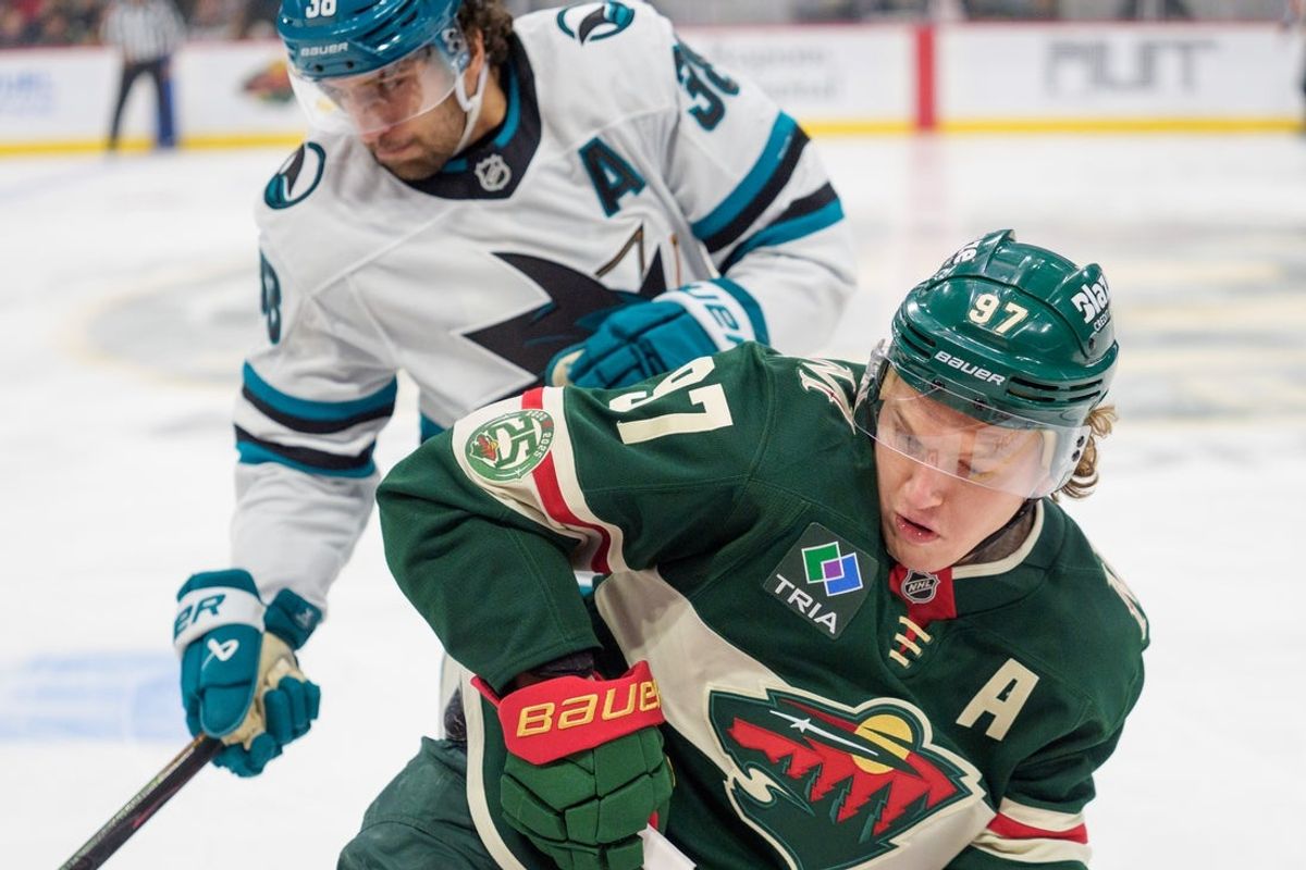 Nov 11, 2025; Saint Paul, Minnesota, USA; San Jose Sharks defenseman Mario Ferraro (38) checks Minnesota Wild left wing Kirill Kaprizov (97) in the first period at Grand Casino Arena. Mandatory Credit: Matt Blewett-Imagn Images