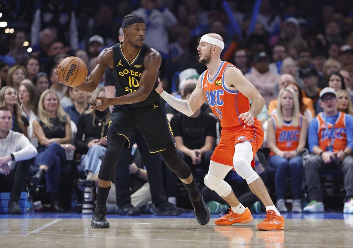 Nov 11, 2025; Oklahoma City, Oklahoma, USA; Golden State Warriors forward Jimmy Butler III (10) moves the ball as Oklahoma City Thunder guard Alex Caruso (9) defends during the second quarter at Paycom Center. Mandatory Credit: Alonzo Adams-Imagn Images