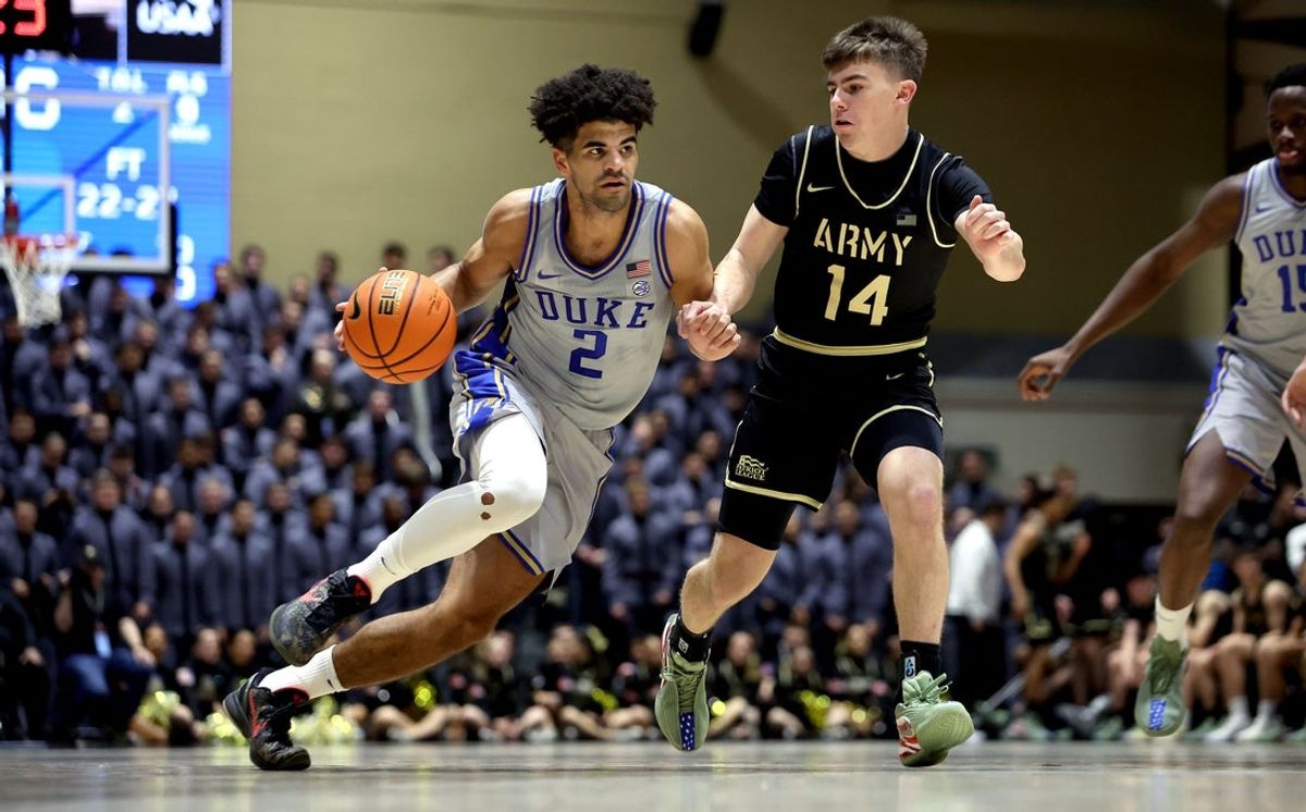 Nov 11, 2025; West Point, New York, USA; Duke Blue Devils guard Cayden Boozer (2) dribbles past Army Black Knights guard Brendon O'Keefe (14) during the second half at Christl Arena. Mandatory Credit: Danny Wild-Imagn Images