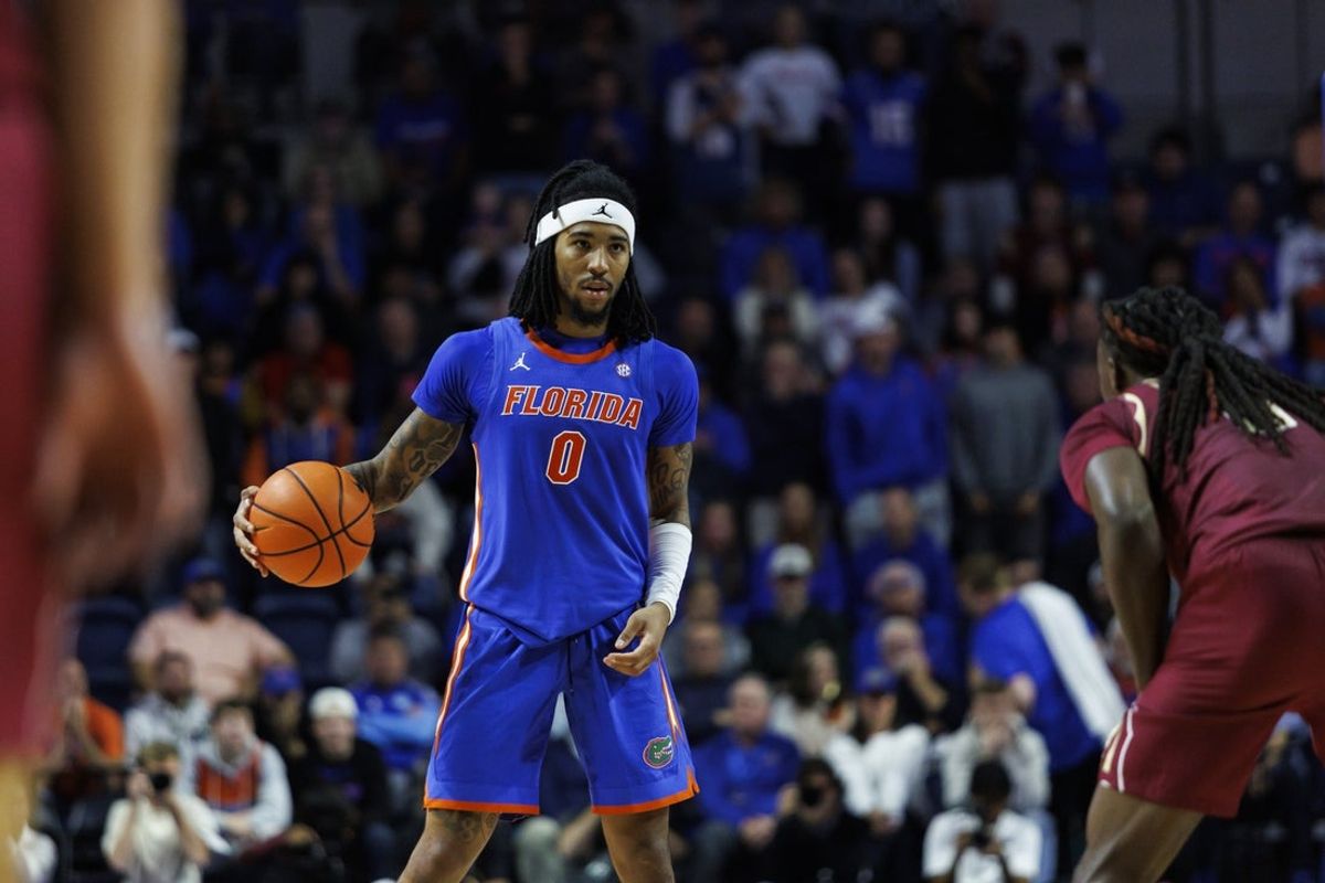 Nov 11, 2025; Gainesville, Florida, USA; Florida Gators guard Boogie Fland (0) dribbles the ball against Florida State Seminoles guard Robert McCray V (6) during the second half at Exactech Arena at the Stephen C. O'Connell Center. Mandatory Credit: Morgan Tencza-Imagn Images