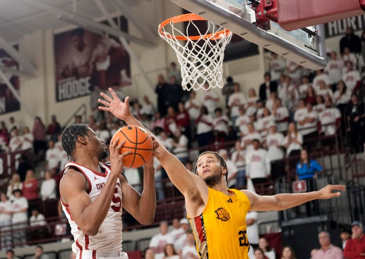 Oklahoma's Mohamed Wague (5) goes up for a basket as Arkansas-Pine Bluff 's Trevon Payton (20) defends in the first half of the college basketball game between the University of Oklahoma Sooners and the University of Arkansas-Pine Bluff at McCasland Field House in Norman, Okla., Tuesday Nov., 11, 2025.