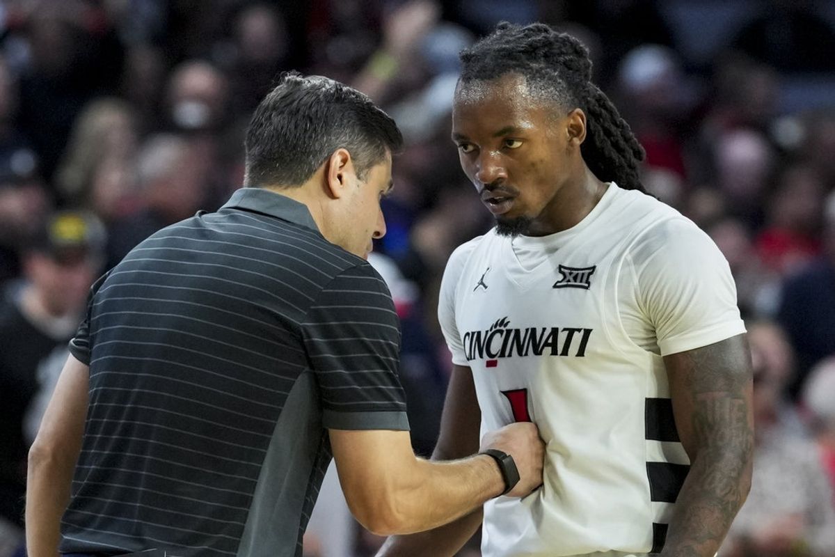 Nov 11, 2025; Cincinnati, Ohio, USA; Cincinnati Bearcats head coach Wes Miller talks with guard Day Day Thomas (1) during a stop in play against the Dayton Flyers in the second half at Fifth Third Arena. Mandatory Credit: Aaron Doster-Imagn Images