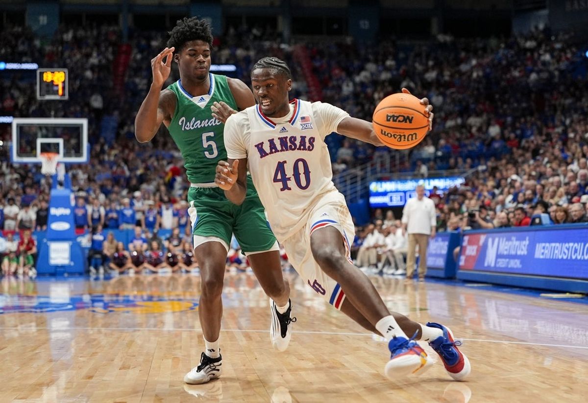Nov 11, 2025; Lawrence, Kansas, USA; Kansas Jayhawks forward Flory Bidunga (40) drives against Texas A&M-Corpus Christi Islanders forward Kobi Pearson (5) during the second half at Allen Fieldhouse. Mandatory Credit: Jay Biggerstaff-Imagn Images