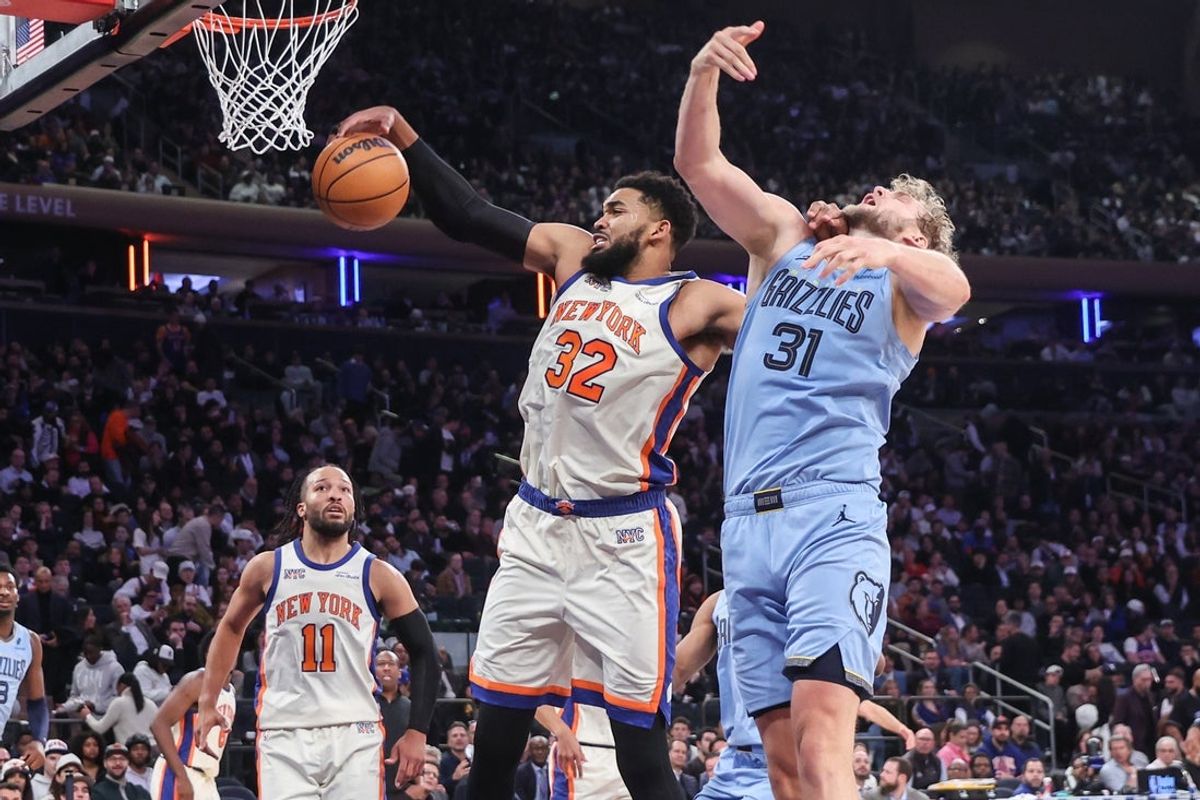 Nov 11, 2025; New York, New York, USA;  New York Knicks center Karl-Anthony Towns (32) and Memphis Grizzlies center Jock Landale (31) battle for a rebound in the third quarter at Madison Square Garden. Mandatory Credit: Wendell Cruz-Imagn Images
