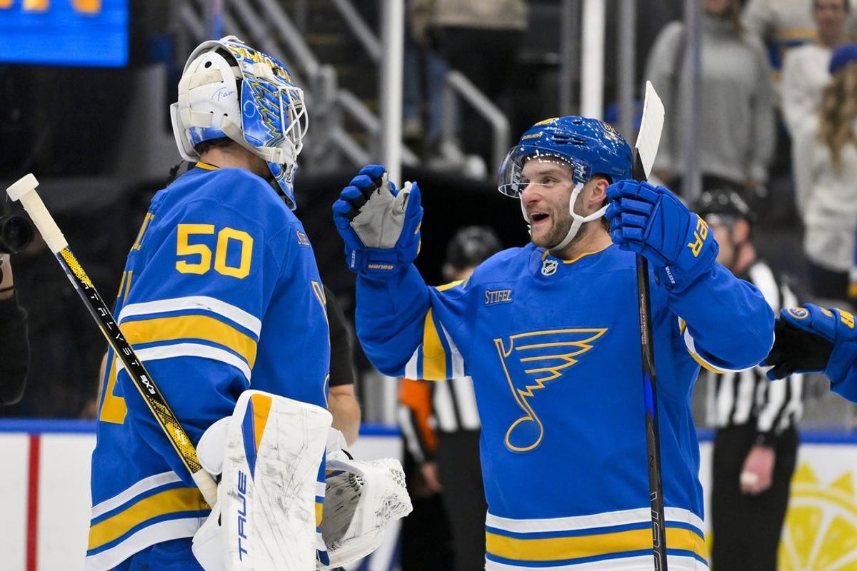 Nov 11, 2025; St. Louis, Missouri, USA; St. Louis Blues goaltender Jordan Binnington (50) celebrates with left wing Nathan Walker (26) after the Blues defeated the Calgary Flames at Enterprise Center. Mandatory Credit: Jeff Curry-Imagn Images