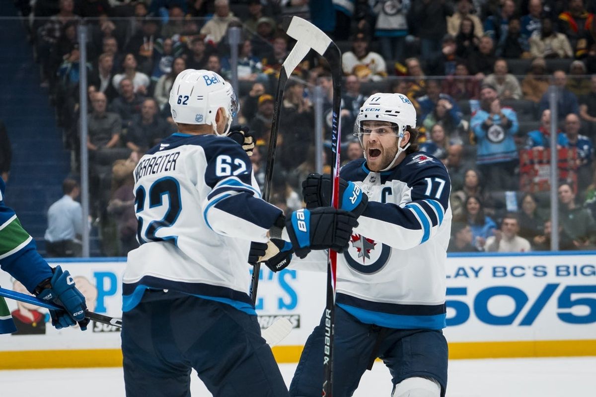 Nov 11, 2025; Vancouver, British Columbia, CAN;  Winnipeg Jets forward Nino Niederreiter (62) and forward Adam Lowry (17) celebrate Niederreiter’s goal against the Vancouver Canucks in the first period at Rogers Arena. Mandatory Credit: Bob Frid-Imagn Images