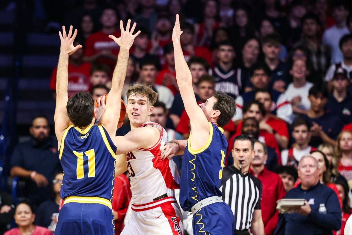 Nov 11, 2025; Tucson, Arizona, USA; Arizona Wildcats center Motiejus Krivas (13) look to pass the ball while the Northern Arizona Lumberjacks attempt to block him during the first half of the game at McKale Memorial Center. Mandatory Credit: Aryanna Frank-Imagn Images
