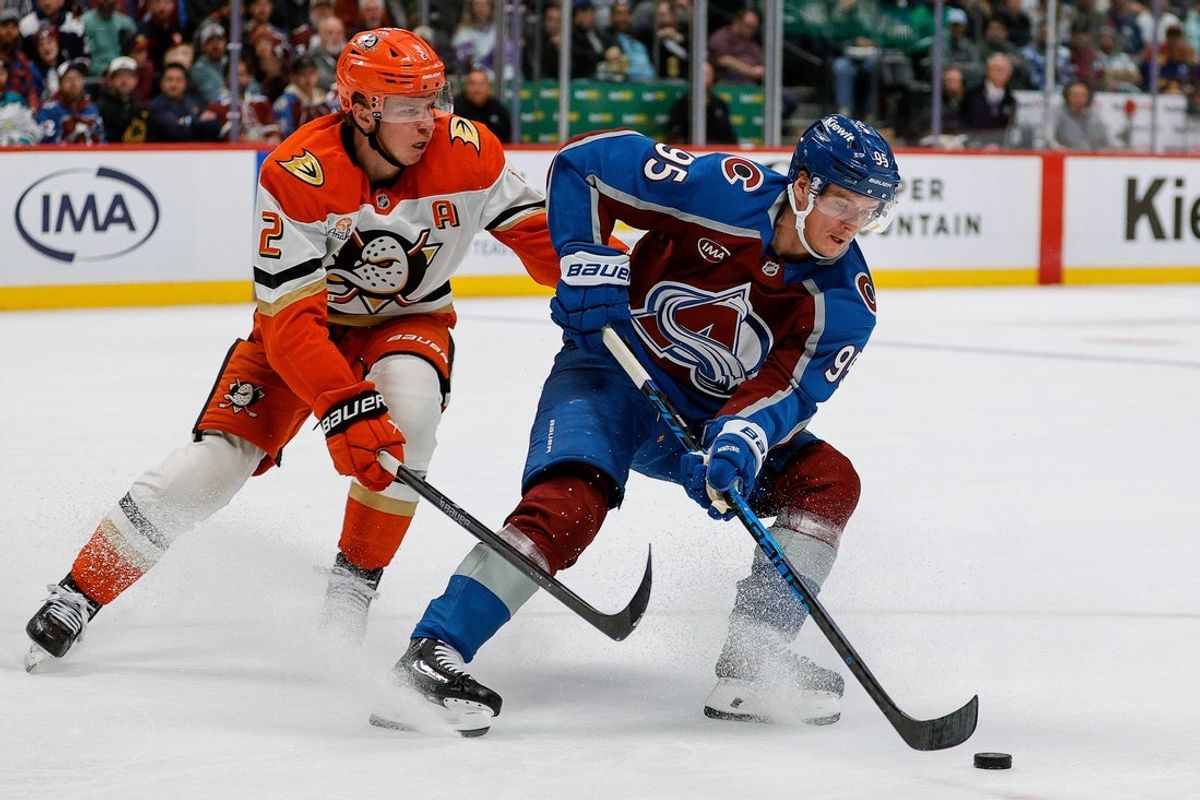 Nov 11, 2025; Denver, Colorado, USA; Colorado Avalanche left wing Victor Olofsson (95) controls the puck ahead of Anaheim Ducks defenseman Jackson Lacombe (2) in the second period at Ball Arena. Mandatory Credit: Isaiah J. Downing-Imagn Images