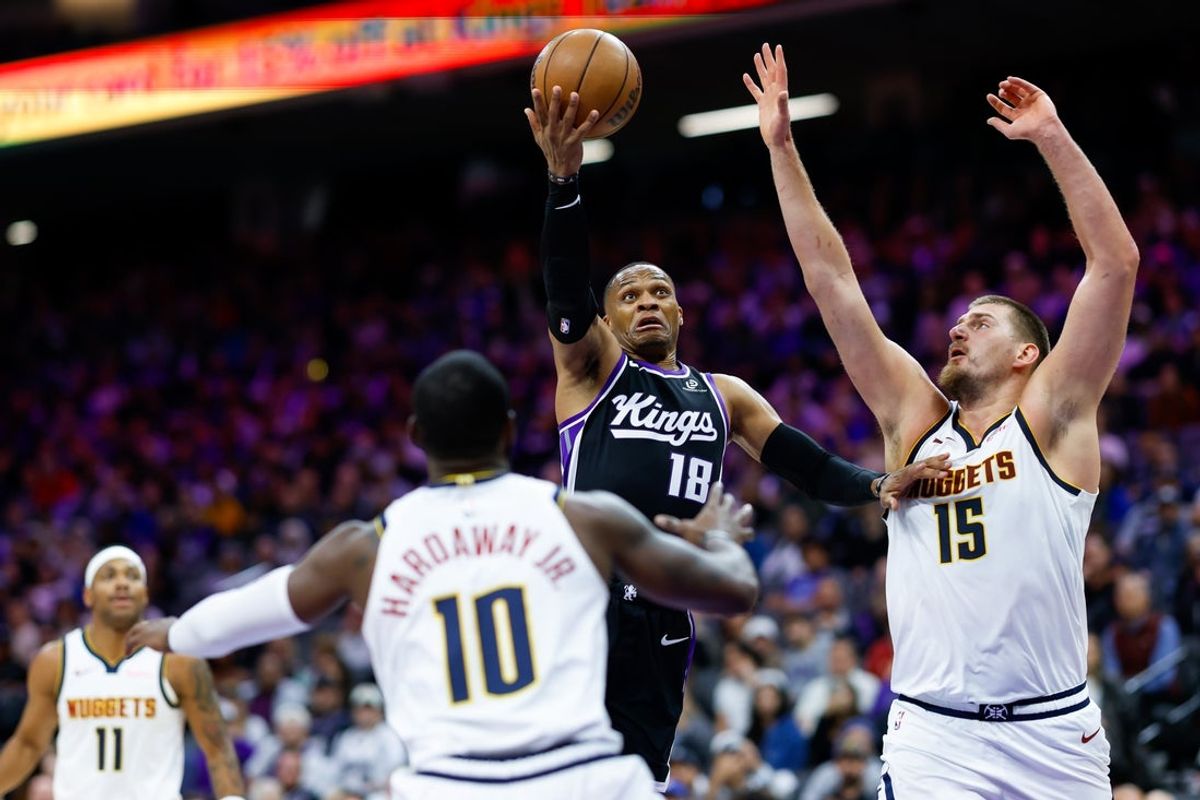 Nov 11, 2025; Sacramento, California, USA; Sacramento Kings guard Russell Westbrook (18) drives to the basket against Denver Nuggets center Nikola Jokic (15) during the fourth quarter at Golden 1 Center. Mandatory Credit: Sergio Estrada-Imagn Images